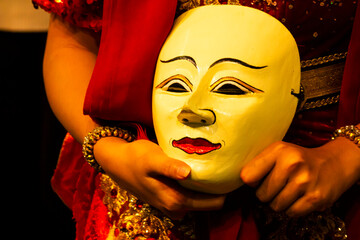 Mask dancer holding a traditionil east java mask