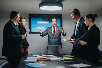 Group of colleagues discussing strategies and ideas during a professional business meeting.