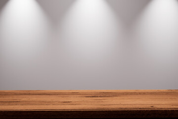 A prominent wooden table with a warm, natural grain serves as the foundation of the scene, set...
