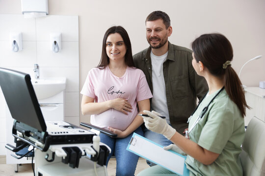 Pregnant couple attending prenatal ultrasound examination in clinic