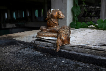  Old broken statue in abandoned hotel. Shabby statue. Scary abandoned hotel. Dirty item.