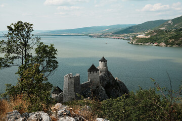 Close-up top view of the towers of Golubac Fortress perched on a rocky hill above the Danube River...