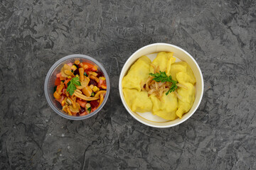 set of mashed potatoes and salad vinaigrette with mushrooms in disposable dishes