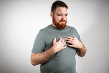 Young man suffering from chest pain, possible heart attack symptoms, medical emergency on isolated...