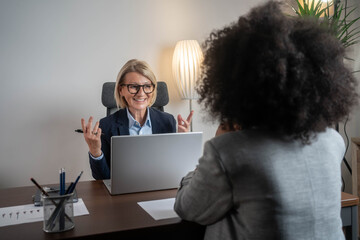 Woman consulting with a female financial manager at the bank.	