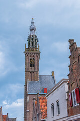 Beautiful Leaning Carillon Tower (De Speeltoren) of the old Church of Our Lady, tilting over Kleine Kerkstraat. The tower was constructed in the 15th and 16th centuries. EDAM, NETHERLANDS.