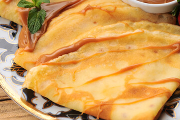 pancakes on a large plate with various jams macro photo