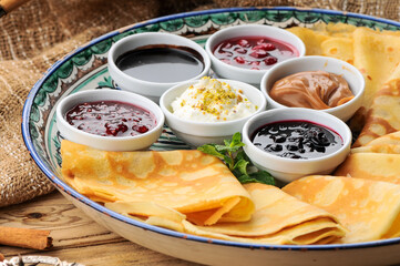 pancakes on a large plate with various jams