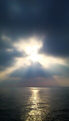 Surreal sunrise over calm sea with subtle mist