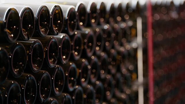 Multiple wine bottles on racks at the Chateau de Cremat winery