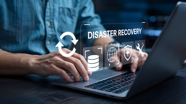 Professional implements modern disaster recovery plan on laptop for secure data backup solutions