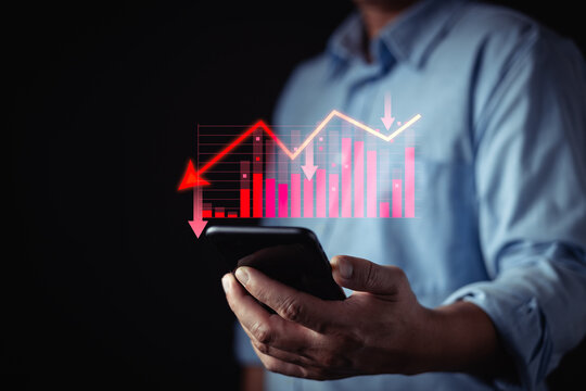 person uses a smartphone while a glowing red digital stock chart with arrows and bars floats above, financial analytics, bear market downtrends,and economic fluctuations. crisis and recession.