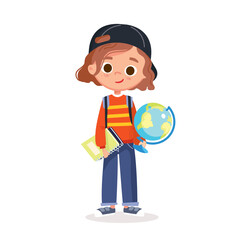 Isolated image of little girl standing upright, holding a globe and a spiral-bound workbook, wearing a backward baseball cap, a sweater and jeans. Сhild looking forward and smiling. Full-body cutout.