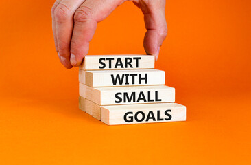 Start with small goals symbol. Concept words phrase Start with small goals on beautiful wooden...