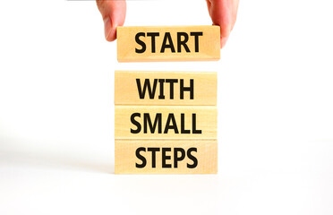 Start with small steps symbol. Concept words phrase Start with small steps on beautiful wooden...