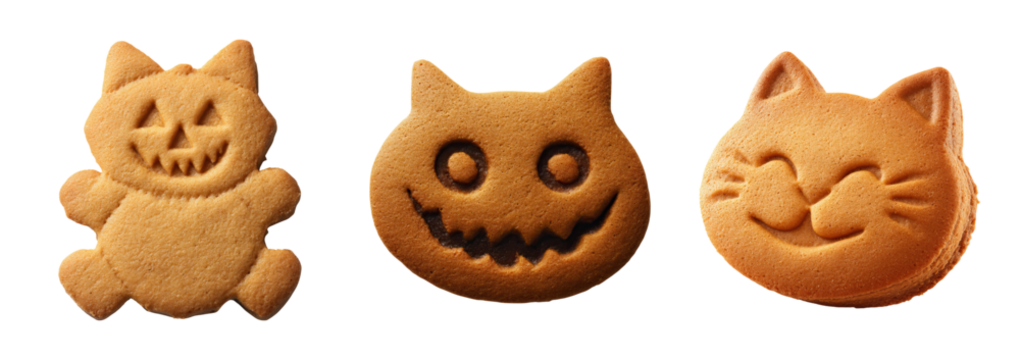 Halloween dessert cookies shaped like cute and spooky cat faces with joyful and eerie expressions