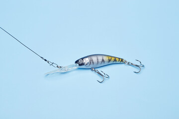 Fishing bait wobbler jig isolated on the bright blue fond background