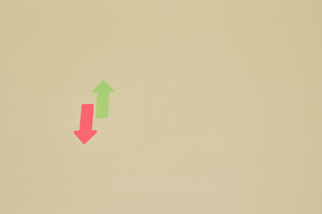 Two red and green arrow stickers located in opposite directions up and down as ascending and descending progress or showing growth and drops of stock market or up-down direction concept