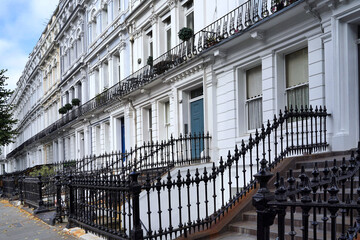 Long row of townhouses with iron railings typical of central London