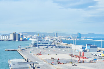 Panoramic view of Barcelona port with cruise ships and city skyline in the background