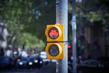 Red bicycle traffic light mounted on a street pole in the city