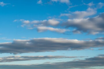 Blue sky with scattered white and grey clouds image
