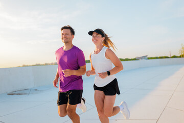 Fototapeta premium Couple enjoys morning jog on a rooftop overlooking the city skyline