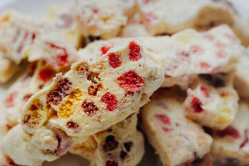 Closeup image of a full plate of delicious homemade sweet nougat cookies on a white plate for...