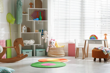 Stylish playroom with toys and furniture. Interior design