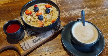 Cozy Breakfast at Roadside Café with Oatmeal, Berries, and Cappuccino