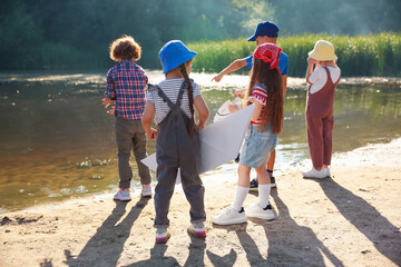 Children spending time by lake in nature