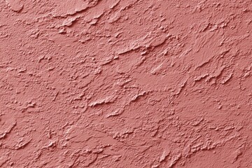Textured pink plaster wall surface with rough pattern