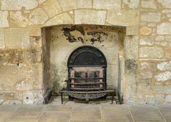 Cast iron ornate grate in fireplace in the empty building shell of Appuldurcombe House near Wroxall...