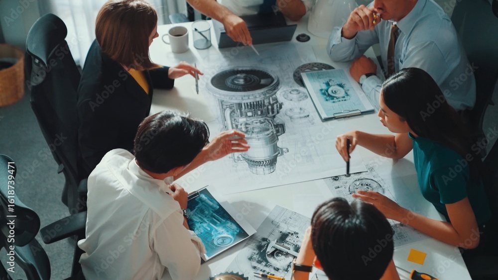 Poster group of diverse team planning strategy while sitting at table with project plan. top aerial view of