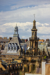 Fototapeta premium A panoramic view captures the historic skyline of Edinburgh, Scotland, under a partly cloudy sky