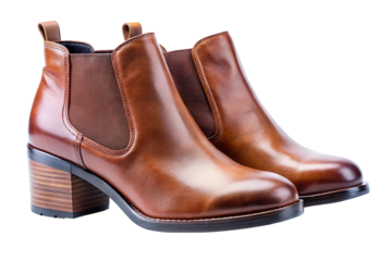 Stylish brown leather chelsea boots with elastic side panels and chunky block heels isolated on transparent background