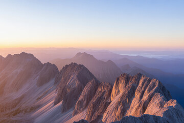 Fototapeta premium Jagged mountain peaks at sunrise mountain range dawn