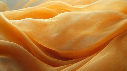 Close-up view of flowing, golden-orange fabric.