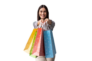 Cheerful female model presenting vibrant shopping bags against transparent backdrop, ideal for...