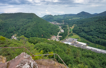 Palatinate Forest, Germany: Panoramic view of forested valleys, a village, and a distant Trifels...
