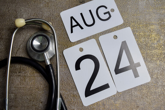 Date of August 24th and stethoscope on wooden table. Save the date. Day of the year concept