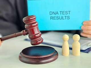 Courtroom scene with gavel and DNA test results in hands of a legal
