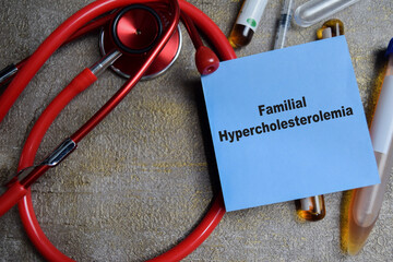 Concept of Familial hypercholesterolemia write on sticky notes isolated on Wooden Table. healthcare...