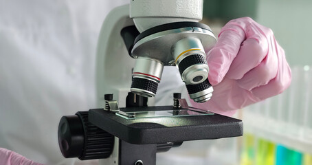 Expert conducting microscopy research with laboratory equipment and colorful samples concept