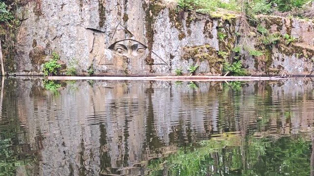 Lipnice nad Sazavou, Czech Republic,  2025-07-26. The engraved eye (Zlaty voci) above clear water of abandoned granite mine