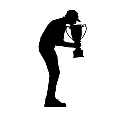 A silhouette of a man celebrating a win by kissing his trophy.