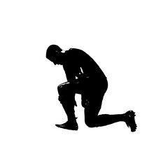 Silhouette of a football player kneeling down.