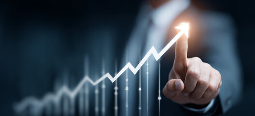 Businessman touching a glowing upward arrow graph symbolizing business growth, success, and financial progress


