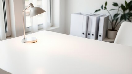 Bright minimalist office desk with lamp and folders
