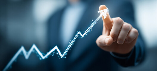Businessman touching a glowing upward arrow graph symbolizing business growth, success, and financial progress

